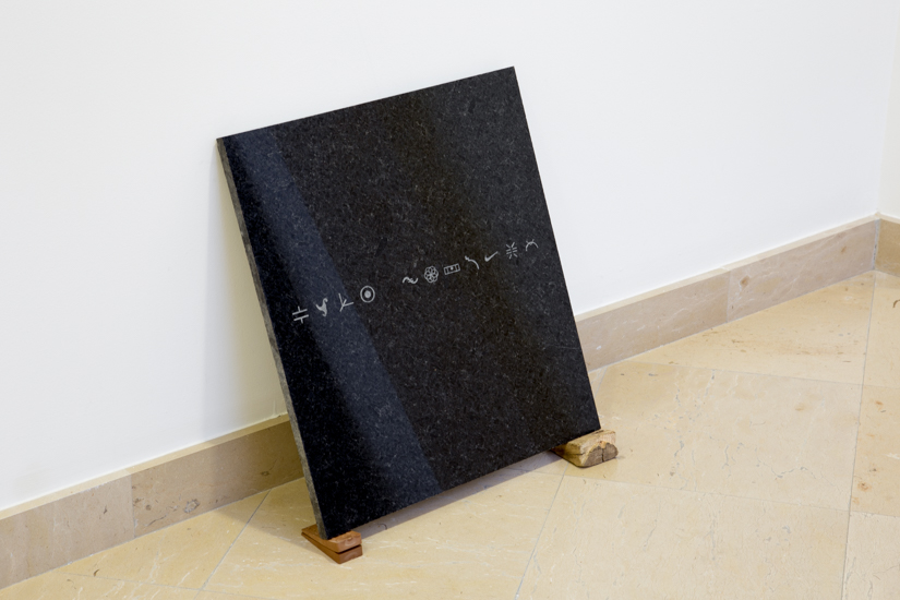 Santiago Reyes Villaveces Repertory (ideograms), 2016, sandblast on granite, wood (guayacan) rubber, 50 x 50cm.