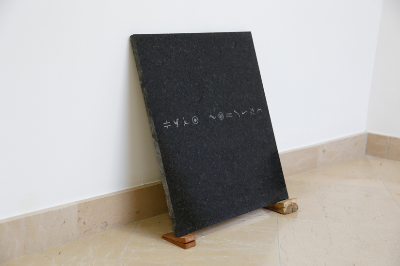 Repertory (ideograms), 2016, sandblast on granite, wood (guayacan) rubber, 50 x 50cm.