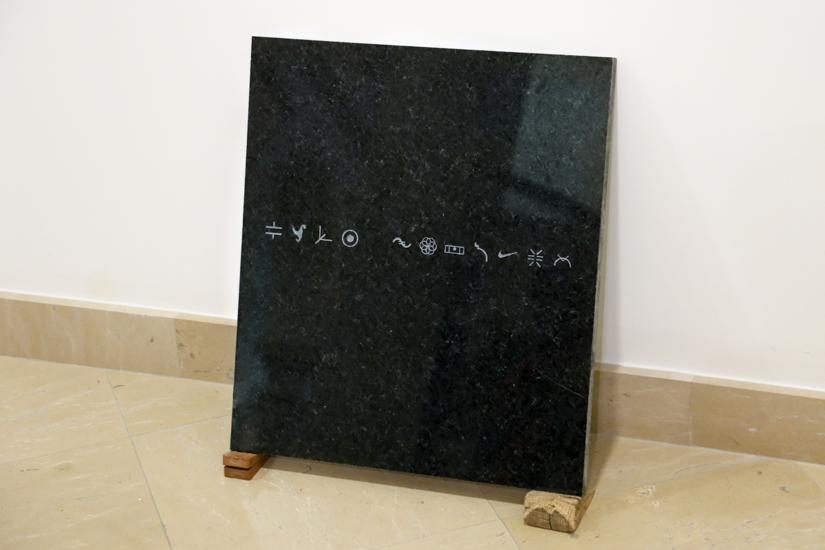 Repertory (ideograms), 2016, sandblast on granite, wood (guayacan) rubber, 50 x 50cm.